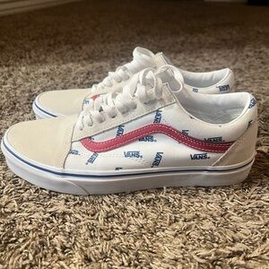 Vans Old Skool sneakers with a white and blue logo pattern and a red sidestripe